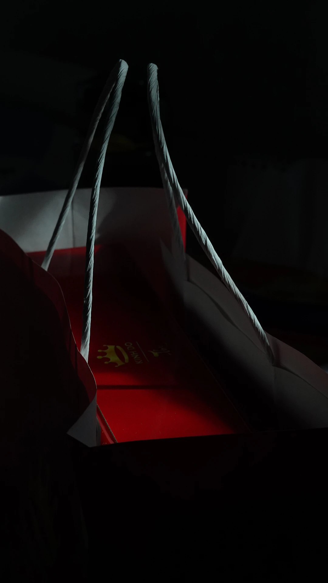 a paper bag sitting on top of a red box