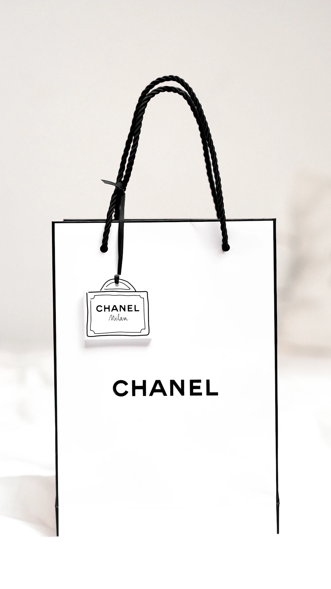 black leather sling bag on white textile