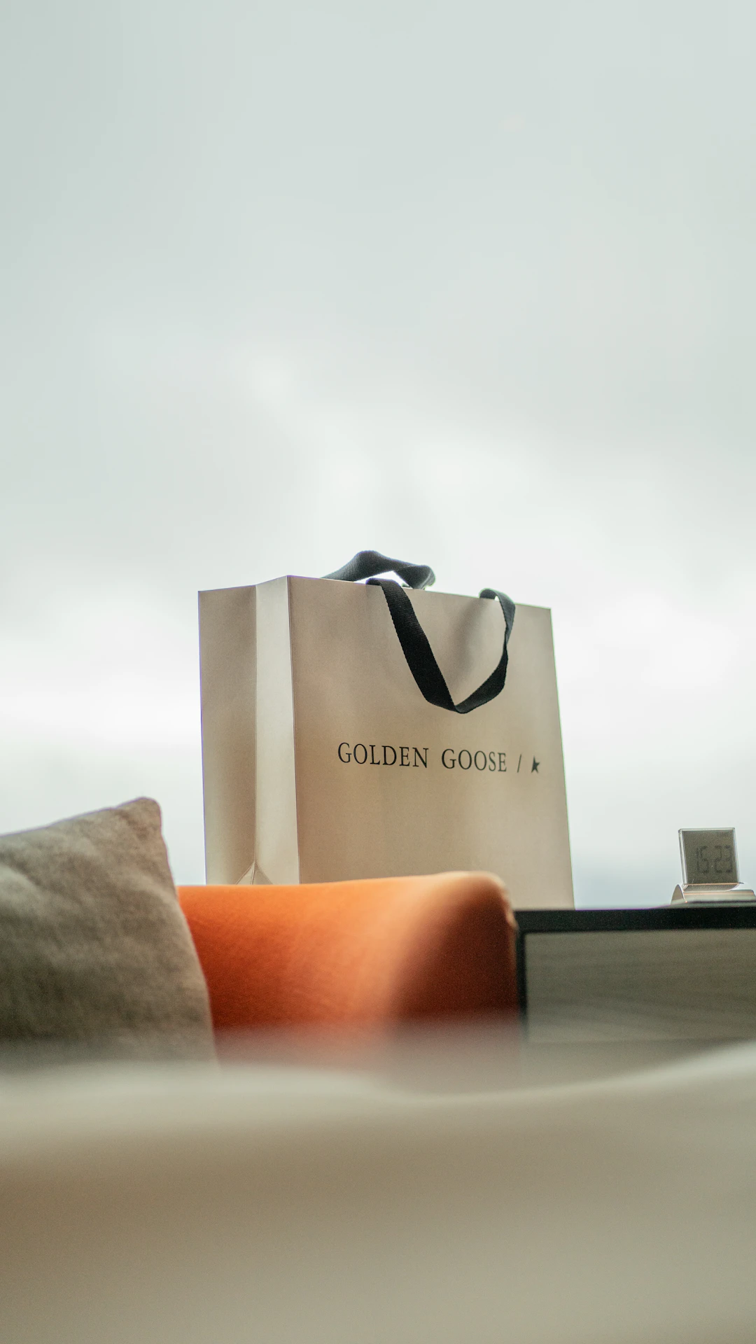 a bag sitting on top of a bed next to a pillow